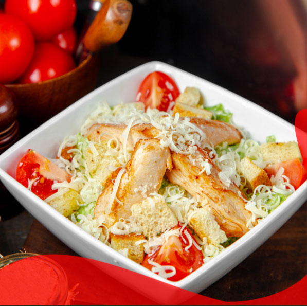 Ali’s Takeaway Bowl of chicken Caesar salad with grilled chicken slices and shredded cheese.
